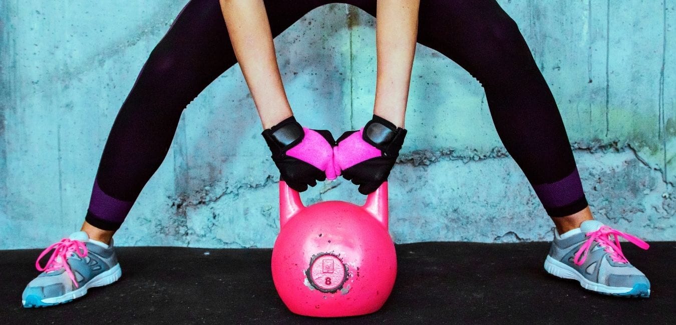 Theres NO Right Way Just the Right Thing Fitness Consistency. Woman lifting pink kettle bell in gym.
