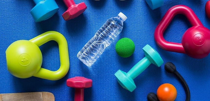 If Freedom is a Priority, Fitness will Follow - blue yoga mat with colorful hand weights, kettle bells and a water bottle.