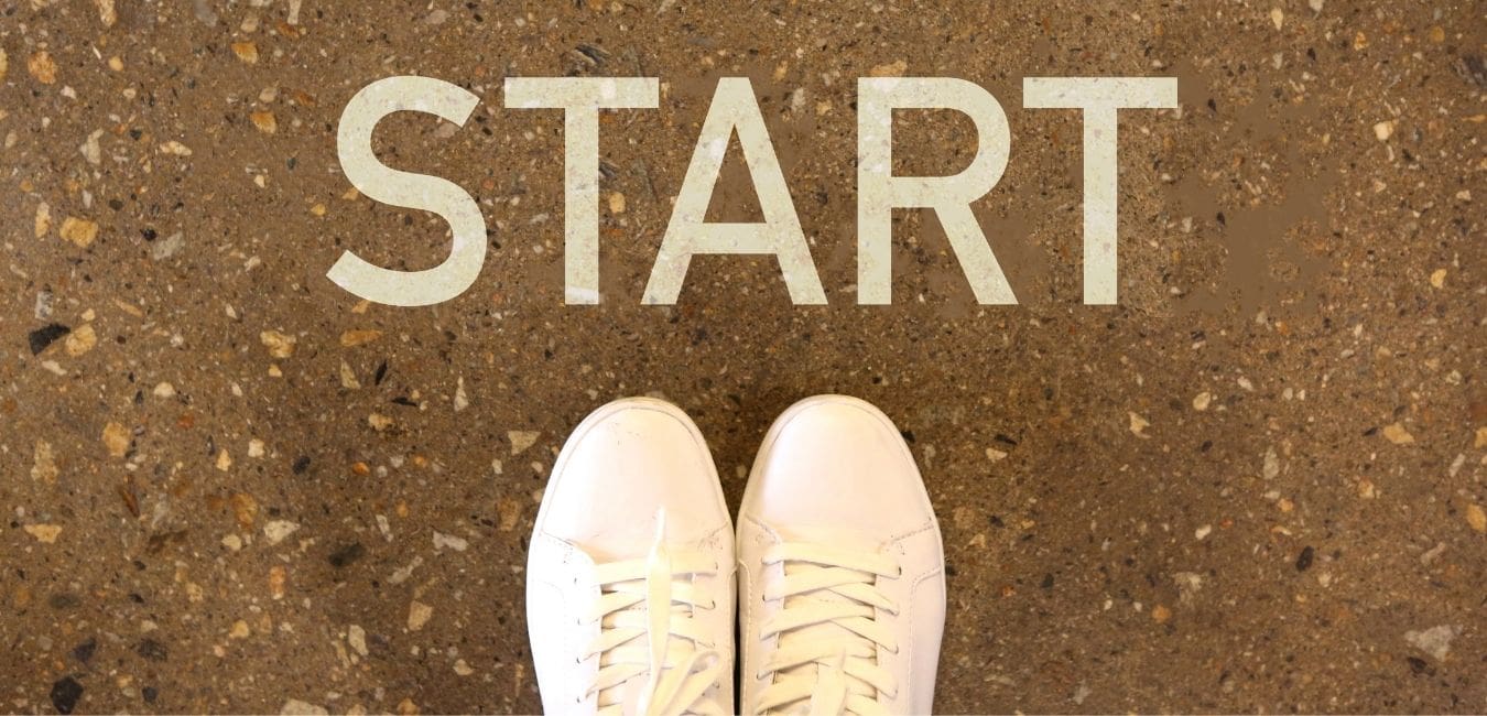 Always starting over. Looking down onto two white sneakers with the word "START" above them.