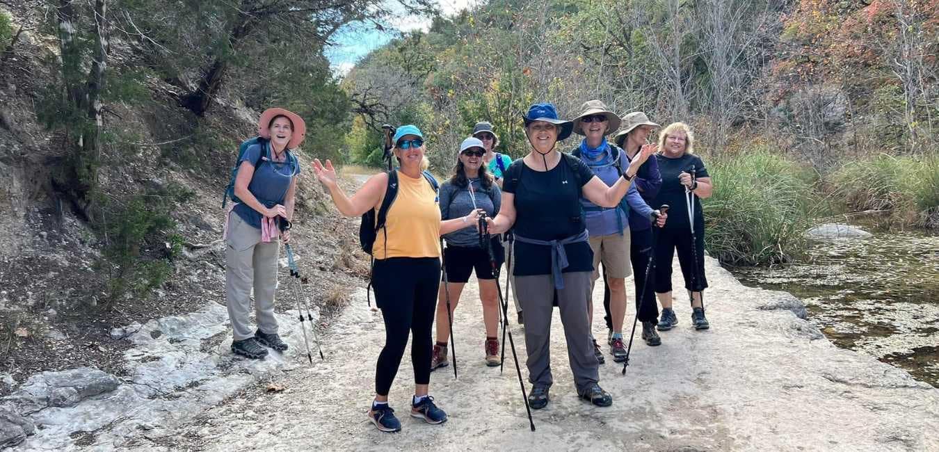 What's Working for These Women's Fitness - Today! Group of women hikers posing for picture on a forest trail.